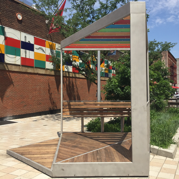 Plaza Perch, Side View With Left Bench Austin Thomas Works Materials on the artwork include; stainless Steel with bead-blasted coating, reclaimed wood decking on the platforms, benches and seat backs, acrylic (3Form) paneled trellis and hardware.