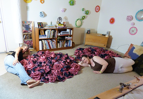 The aritst playing with friend Blair Schweiger after designing the Rose Clusters on the floor. Push Down & Tango