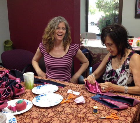 The artist coaches a Maker in sewing a Resiliency Rose at the first Maker Party. Push Down & Tango