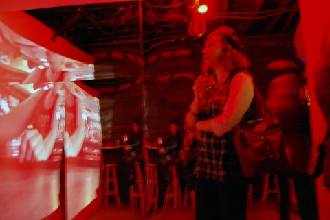 The Last Resort - Installation View, Krowswork Gallery - Oakland, CA Cybele Lyle The Last Resort at Krowswork Gallery Video Projection, Wood Stools, Wood Bar, Mirrored Plexi, Dart Board, Red Light, Beer