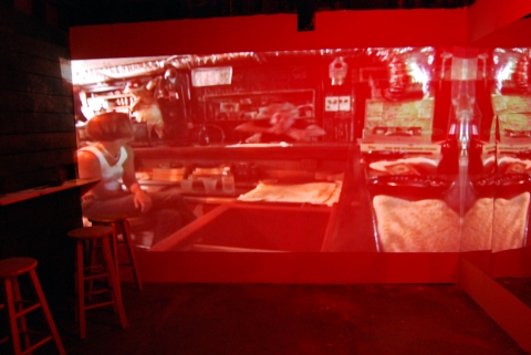 The Last Resort - Installation View, Krowswork Gallery - Oakland, CA Cybele Lyle The Last Resort at Krowswork Gallery Video Projection, Wood Stools, Wood Bar, Mirrored Plexi, Dart Board, Red Light, Beer