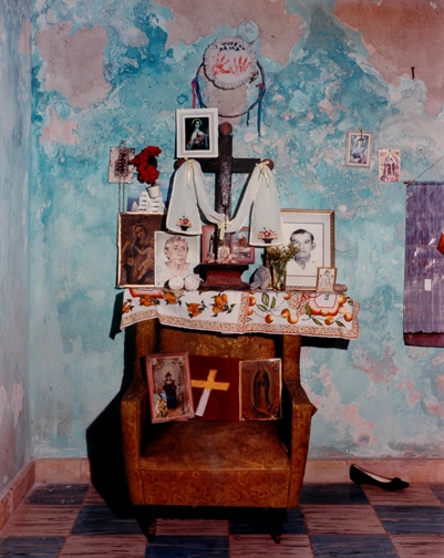 Blue wall, chair, shelf with photos and Cross Jane Deering Gallery Dana Salvo C-print