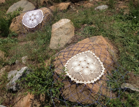 Dwell s i t e specific crocheted doilies stretched over found rocks