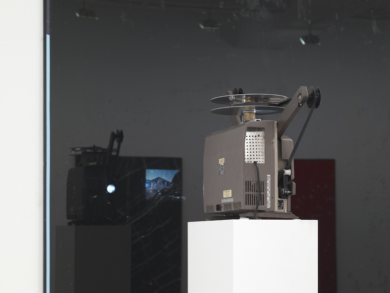 Sundial/Substrate/Scene Marc Handelman Geological Sketches at Home and Abroad Glass, oil paint, 16mm projector with looper, color 16mm film (2 min), pedestal and hardware
