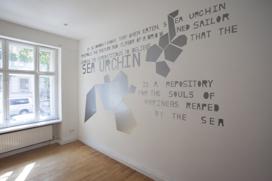 SEA URCHIN mark booth PIERCEDSTARNIGHTVOICE Text in silver hand-cut adhesive vinyl on wall.