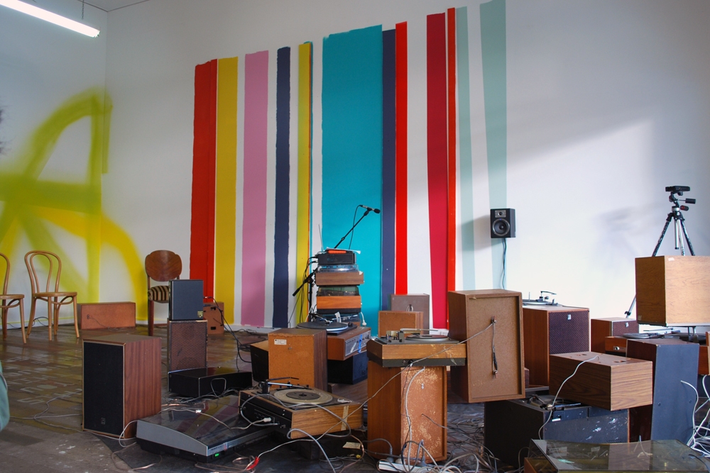 mark booth THE SOUND OF THE WORD SPEED / THE SPEED OF THE WORD SOUND Turntables, Loudspeakers, three channel audio, paint, adhesive vinyl, tarp, wood mark booth THE SOUND OF THE WORD SPEED / THE SPEED OF THE WORD SOUND Turntables, Loudspeakers, three channel audio, paint, adhesive vinyl, tarp, wood