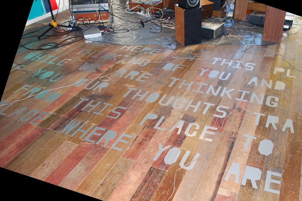 WE ARE HERE, IN THIS PLACE, THINKING OF YOU, AND WHILE WE ARE THINKING OF YOU, OUR THOUGHTS TRAVEL FROM THIS PLACE TO THE PLACE WHERE YOU ARE NOW mark booth THE SOUND OF THE WORD SPEED / THE SPEED OF THE WORD SOUND Hand-cut adhesive silver vinyl