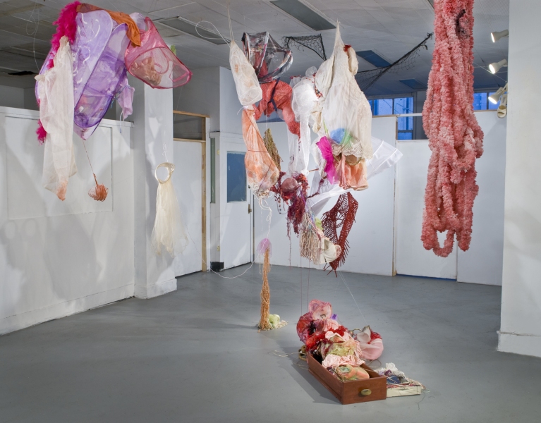 aimee hertog Installation and Sculpture Dresses, wedding veil, dolls, lace, shawl, yarn, string, sock bags, laundry basket, mop tops, loofahs, ribbon, fishing wire, discarded desk drawer, glue, paint.  site-specific installation, Solos Project House, Newark, New Jersey. 