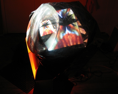 Daniel Healey video sculpture t.v. monitor, stool, mirrors, fresnel lens, mylar, tape, cardboard, light, video