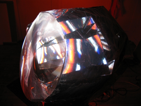 Daniel Healey video sculpture t.v. monitor, stool, mirrors, fresnel lens, mylar, tape, cardboard, light, video