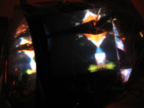 Daniel Healey video sculpture t.v. monitor, stool, mirrors, fresnel lens, mylar, tape, cardboard, light, video