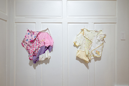 HEIDI BARKUN Unnamed Used baby clothes, thread, dissection pins
