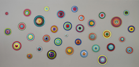 H E I D I   P O L L A R D Wall Reliefs and Sculpture 35 orphan enamel pot lids, artist spray paint