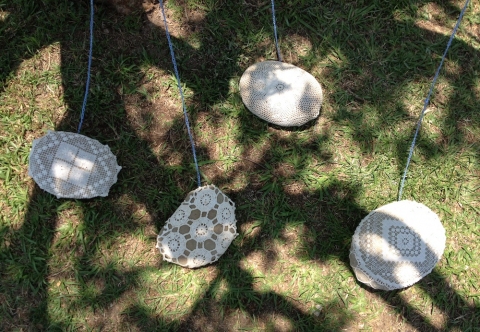  s i t e specific cotton doilies stretched over river rocks