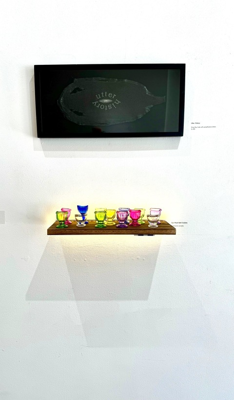  Seeing Through Yesterday with glass eye wash goblets on lit shelf