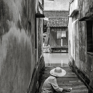 J01-009 Woman Sitting in an Alley