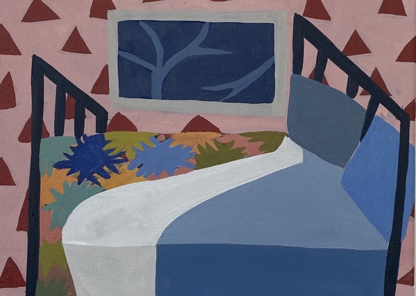 Bed with quilt and blue sheets