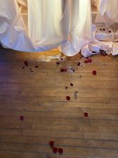 Crash, 2022, shrouded china cabinet, crown, rose petals, and broken glass