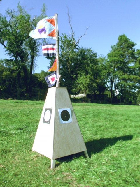 Sheila Ross ~ Artist and Arts Educator Cow Semaphore Nylon Fabric, flags, wood, paint, found log