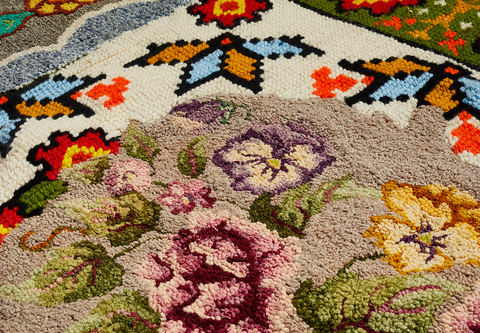 Venetia Dale piecing together collected and stitched together unfinished hooked rugs 